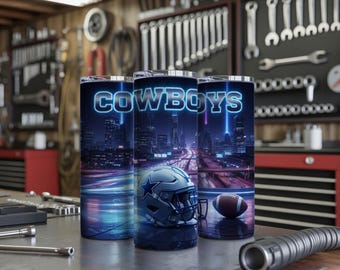 May include: Three stainless steel tumblers with a "COWBOYS" design. The design features a night cityscape with a football helmet and a football. The text "COWBOYS" is in a neon blue font.