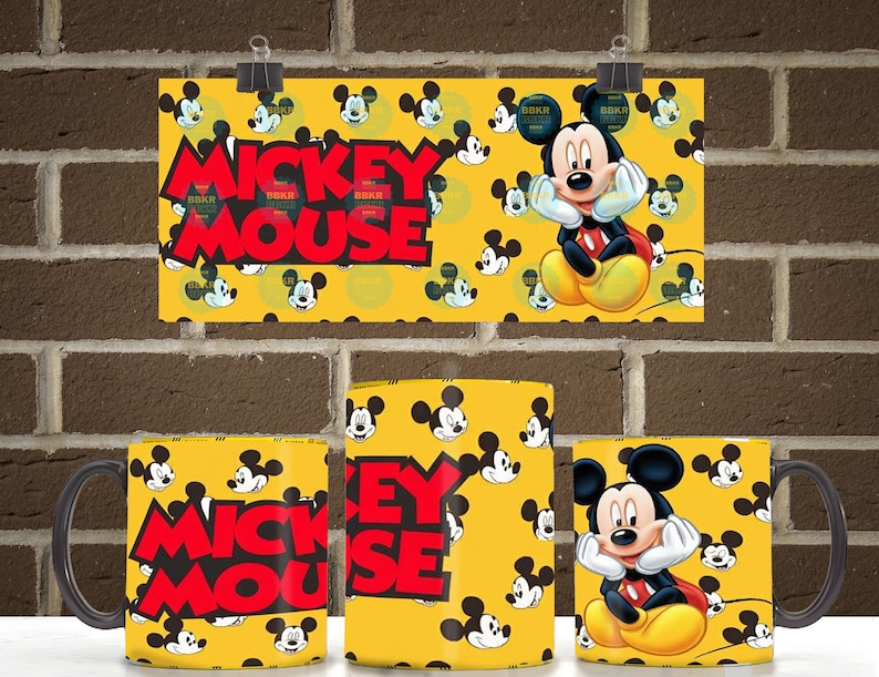 Peut inclure: Un mug en c&eacute;ramique jaune avec un motif r&eacute;p&eacute;titif de t&ecirc;tes de Mickey Mouse et le texte MICKEY MOUSE en lettres rouges grasses. Le design comprend une illustration plus grande de Mickey Mouse posant son menton sur ses mains sur fond jaune.