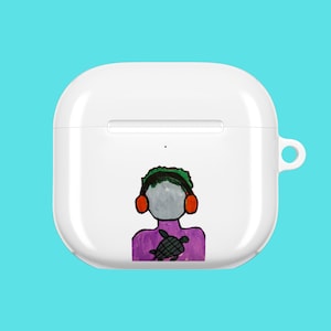 May include: White AirPods case featuring a hand-drawn illustration of a person wearing headphones and holding a turtle. The person is depicted with a gray face, green hair, and a purple shirt. The case has a loop for attaching to a keychain.