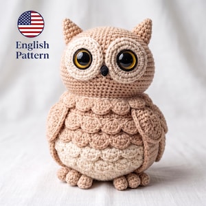 May include: A beige and cream crocheted owl plush toy with large, glossy black and amber eyes, a small black beak, and textured feather-like stitching on the body. The text English Pattern is visible in the upper left corner with a US flag icon.