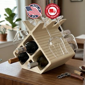May include: A beige wooden wine rack with a geometric design, holding three wine bottles and four wine glasses. The rack has slots for the bottles and angled holders for the glasses. A corkscrew and corks are on the table.