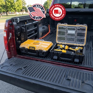 May include: Two black and yellow toolboxes with clear lids sit in the bed of a red truck. One toolbox is open, revealing yellow power tools. The image includes a "Made in USA" sticker and a "Fast Shipping" sticker.