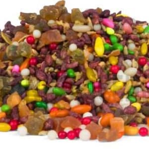 May include: A colorful assortment of mixed candies and treats, including red, white, yellow, and green pieces. The pile of sweets is set against a white background, showcasing a variety of shapes and textures.