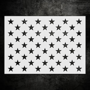 May include: A white stencil featuring a pattern of black stars. The stars are evenly spaced across the rectangular stencil, creating a repeating design. The stencil is likely used for crafts or decorative purposes.