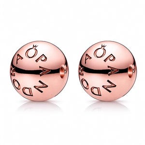 May include: Two spherical rose gold-toned beads featuring a polished metallic finish. Each bead is engraved with the word PANDORA in capital letters, accompanied by a small crown symbol above the letter O, and includes a central hole for threading.