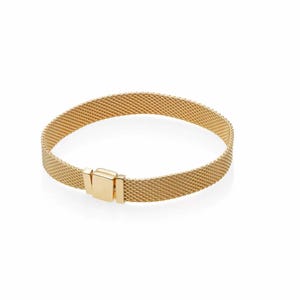 May include: A gold-colored mesh bracelet with a rectangular clasp. The bracelet is made of a fine, woven material, and the clasp is a solid, rectangular shape. The bracelet is designed to be worn around the wrist.