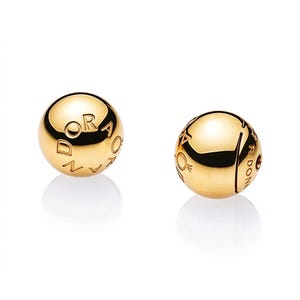 May include: Two spherical gold-toned beads with a polished, reflective surface. Each bead features the engraved text PANDORA along with a small crown logo symbol. The beads are round and smooth, designed with a central hole for threading onto jewelry.