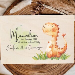 May include: Wooden keepsake box with a watercolor illustration of a friendly orange dinosaur. The box is personalized with the name "Maximilian", date, time, length (48cm), and weight (2950g) in black script.