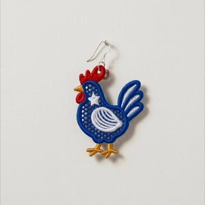 May include: A single rooster-shaped earring with a silver hook. The embroidered design features a blue body with white accents, a red comb, and yellow feet. A white star is on the rooster's chest.