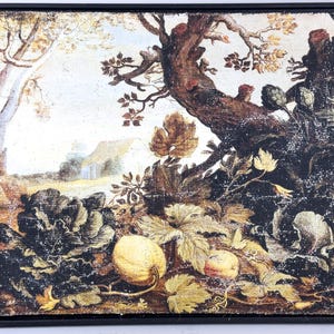 May include: Framed landscape painting featuring a detailed depiction of a garden scene. The artwork showcases a variety of plants, including cabbages and gourds, with a large tree in the background. The color palette includes shades of brown, green, and yellow.