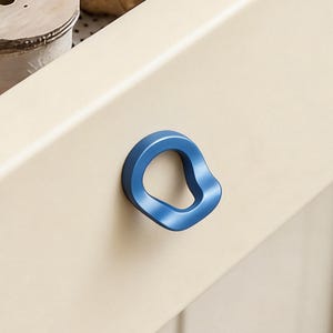 May include: A white ceramic mug with a black handle and the text "But First, Coffee" in a black, bold font. The mug is on a white surface. The mug is 4 inches tall.