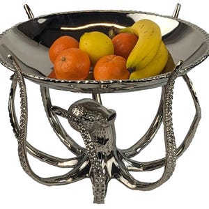 May include: A set of three ceramic mugs with a speckled, matte finish. Each mug is a different colour: light blue, cream, and grey. The mugs have a simple, modern design with a rounded shape and a comfortable handle.