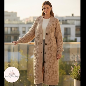 May include: A long, beige cable-knit cardigan with large brown buttons. The open-front sweater features a textured pattern and long sleeves. The cardigan is knee-length and appears to be made of a soft, warm material.