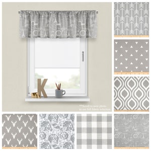 May include: A collection of 10 different fabric swatches in shades of gray with various patterns, including arrows, triangles, swirls, deer, tie-dye, plaid, and a Parisian-themed design.  The swatches are displayed on a white background with a ruler for scale.
