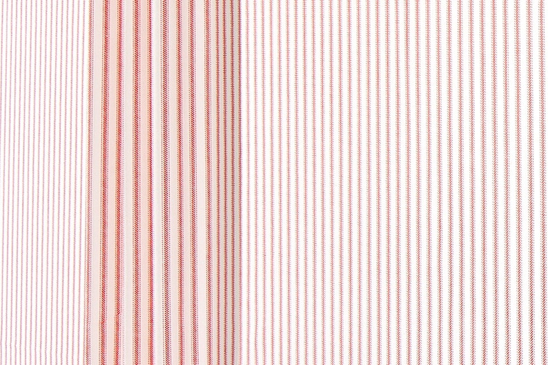 May include: White fabric with thin red stripes. The stripes are evenly spaced and create a subtle pattern.