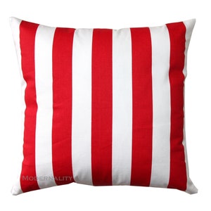 May include: Red and white striped throw pillow. The pillow is made of a soft, comfortable fabric and has a classic striped design.
