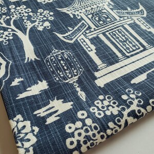 May include: Blue fabric with a white design of a pagoda, trees, and flowers. The fabric has a textured, linen-like appearance. The text "MODERNALITY HOME DECOR" is visible at the bottom of the image.