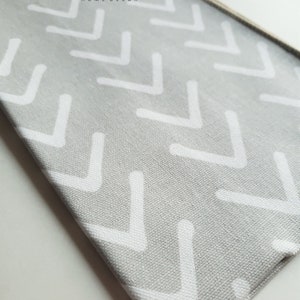 May include: Grey fabric with a white chevron pattern. The fabric has the text "MODERNALITY HOME DECOR" printed on it.