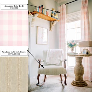 May include: A rocking chair with a white throw blanket on it, in a room with pink and white gingham curtains, a wooden shelf with books, and a wooden side table with a vase of flowers. The chair is upholstered in a beige fabric with a subtle texture. The text "Antelope Gobi Slub Canvas ANTELGOBSC" is visible in the image.