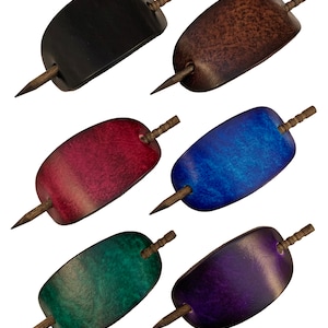 May include: Six leather hair clips with wooden pins. The clips are in various colors: black, brown, red, blue, green, and purple.