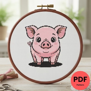 May include: A cross-stitch pattern of a pink piglet in a wooden embroidery hoop. The piglet has large eyes, a small tail, and is standing on a black shadow. The pattern is labeled "PDF Pattern" in a red circle.