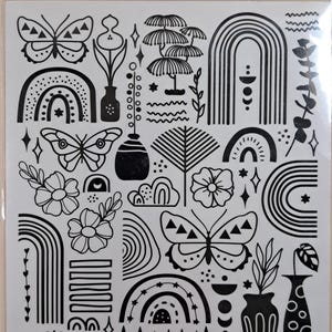 May include: A sheet of black and white rub-on transfers with diverse designs. The designs include butterflies, flowers, rainbows, trees, and geometric shapes. The text "rub-on transfers" is visible at the top.