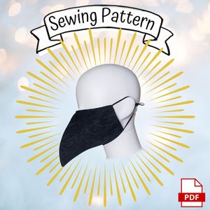 May include: A black face mask with a pointed beak-like shape worn on a white mannequin head. Above the mask is a white banner with the text Sewing Pattern. A PDF icon is located in the bottom right corner, surrounded by yellow sunburst rays.