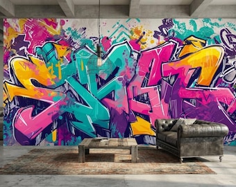May include: A large-scale wall mural featuring vibrant graffiti art with bold, overlapping letters in shades of hot pink, bright yellow, and teal. The design includes energetic paint splatters, drips, and abstract shapes across a white background.