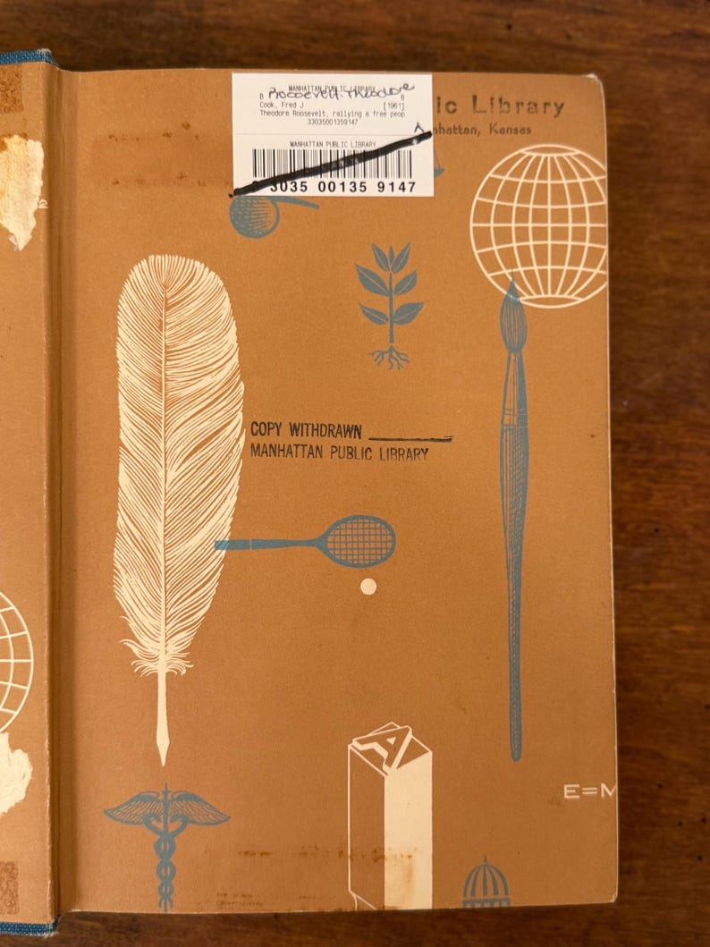 May include: A vintage book cover with a tan background and blue and white illustrations. The cover features a large feather, a tennis racket, a globe, and a paintbrush. Text includes "COPY WITHDRAWN" and "MANHATTAN PUBLIC LIBRARY".