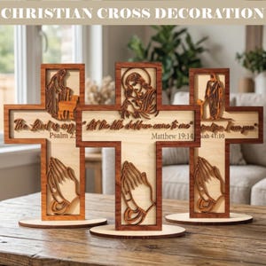 May include: Wooden Christian cross decorations with laser-cut religious figures and Bible verses. Each cross features a unique design, including praying hands and biblical scenes. The text on the crosses includes "The Lord is my Psalm 23", "Let the little children come to me Matthew 19:14", and "I am you Isaiah 41:10".