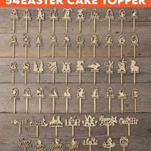Puede incluir: Un conjunto de 54 adornos de madera para pasteles de Pascua. Los adornos presentan diseños temáticos de Pascua, incluyendo conejos, huevos y la frase "Happy Easter". Se muestran sobre una superficie de madera.