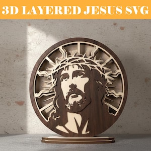 May include: A 3D layered wooden art piece featuring the image of Jesus with a crown of thorns. The artwork is circular, with a dark brown outer layer and a lighter wood inner layer. The text "3D LAYERED JESUS SVG" is at the top.