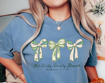 Christian St Patrick’s Day Shirt for Women – Not Lucky Simply Blessed Bible Verse Romans 4:7-8 Tee with Green Bows and Faith Design