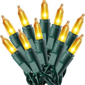 May include: A string of decorative holiday lights featuring ten glowing amber-colored bulbs. Each bulb is set into a dark green plastic base, connected by a dark green wire. The lights are arranged in a cluster, emitting a warm, bright yellow glow.