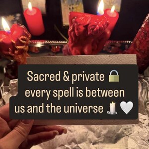 May include: A collection of red candles with lit flames, arranged on a surface. The image includes a card with the text "Sacred & private, every spell is between us and the universe."