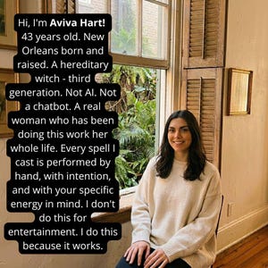 May include: A woman with long dark hair smiles, seated near a window with wooden shutters. Text on the left reads, "Hi, I'm Aviva Hart!" and describes her as a hereditary witch. She wears a cream-colored sweater.