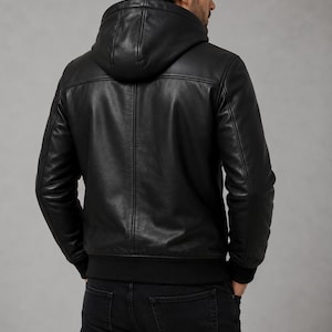 Back view of men's black leather hooded jacket with hood and smooth leather finish