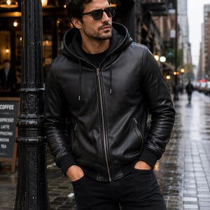 Man wearing a black genuine leather hooded jacket with front zipper