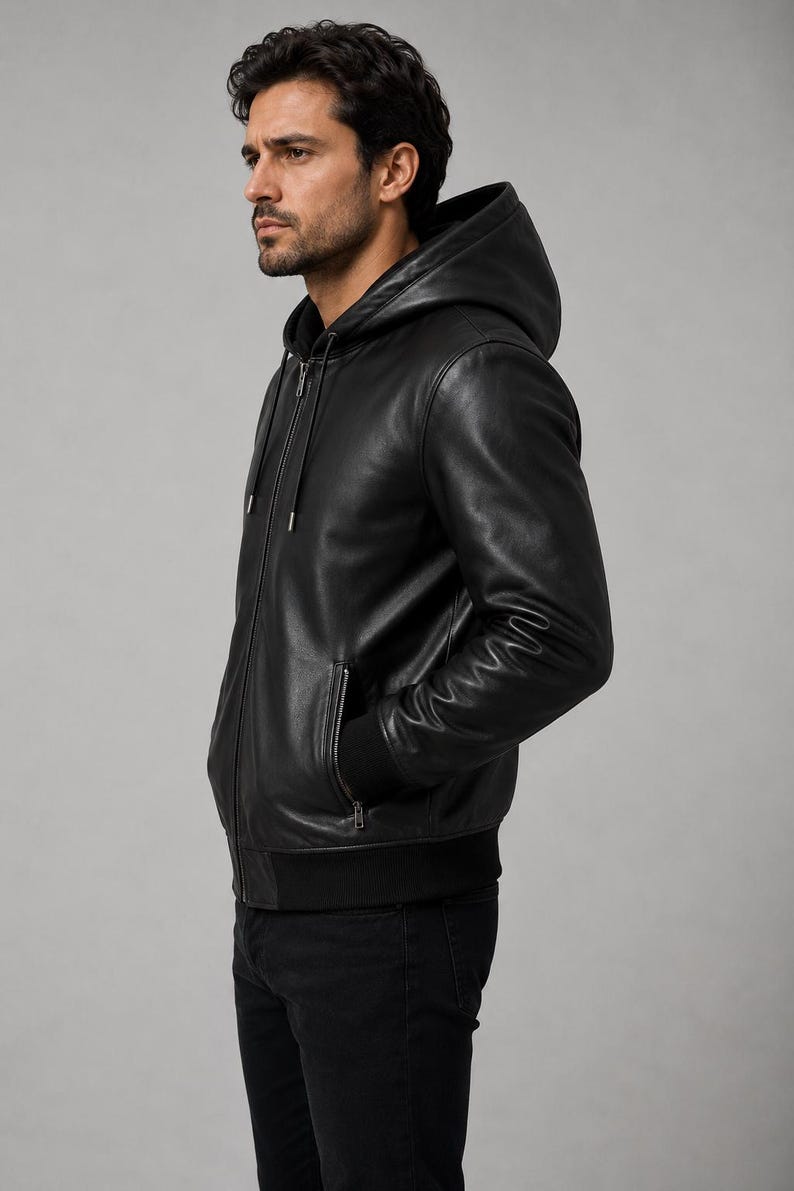 Side view of black leather hooded jacket showing fitted silhouette and sleeve details