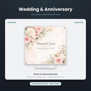 May include: A square personalized acrylic print featuring a floral design with pink and white roses and green leaves. The text reads Michael & Sarah, 06.14.2025, and Charity suffereth long, and is kind, 1 Corinthians 13:4. It sits on a clear acrylic base.