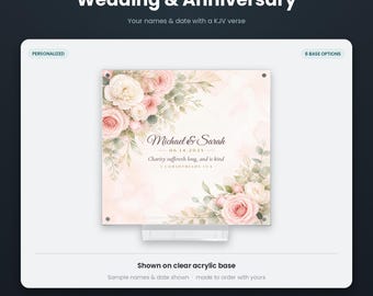 May include: A square personalized acrylic print featuring a floral design with pink and white roses and green leaves. The text reads Michael & Sarah, 06.14.2025, and Charity suffereth long, and is kind, 1 Corinthians 13:4. It sits on a clear acrylic base.
