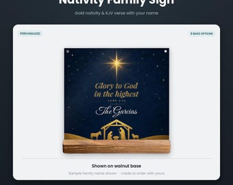 May include: A square plexiglass sign featuring a gold nativity scene and the text Glory to God in the highest Luke 2:14 The Garcias set against a dark blue starry background. The sign is mounted on a rectangular wooden walnut base.