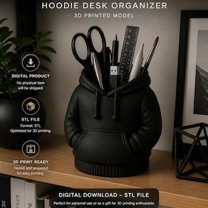 May include: A black 3D-printed desk organizer shaped like a hoodie, holding scissors, pens, a ruler, and other stationery items. The text on the image reads "HOODIE DESK ORGANIZER - 3D PRINTED MODEL" and "DIGITAL DOWNLOAD - STL FILE".