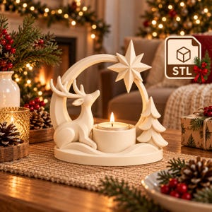 May include: A cream-coloured candle holder featuring a sculpted deer, a stylised pine tree, and a large star suspended within a circular frame. A lit tea light candle sits in the centre base. The design includes an STL file icon in the corner.