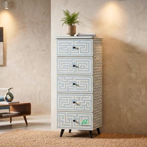 May include: Tall, five-drawer cabinet with a light blue and white maze pattern. The cabinet has black knobs and legs. A small plant in a tan pot sits on top. The cabinet is approximately 60 inches tall.