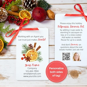 May include: White gift tags with red ribbon, featuring text and illustrations for a holiday potpourri simmer pot. The tags include contact information and a QR code, with a festive arrangement of dried oranges, cinnamon sticks, and pine.