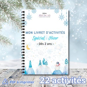 May include: A winter-themed activity book with a spiral binding. The cover displays a watercolour illustration of a snowy scene with a snowman, trees, and a crescent moon. Text includes "MON LIVRET D'ACTIVITÉS Spécial: Hiver - Dès 2 ans -" and "22 activités".