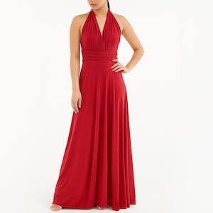 Può includere: Un abito lungo rosso con scollo all'americana, scollatura a V e gonna fluida. L'abito presenta un corpetto arricciato e una vita aderente. La modella indossa l'abito, su sfondo bianco.