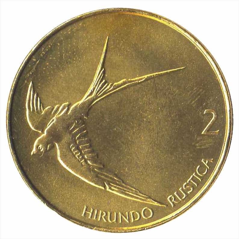 May include: A gold-colored coin with a swallow in flight on the front. The coin has the text "HIRUNDO RUSTICA" and the number "2" on the bottom.
