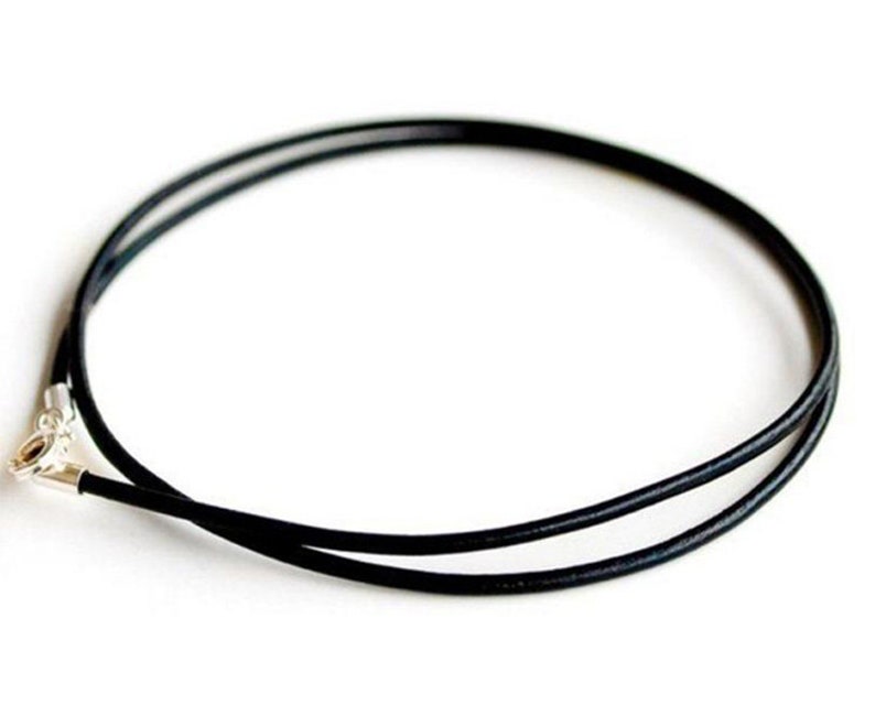 May include: A black leather cord necklace with a silver clasp.